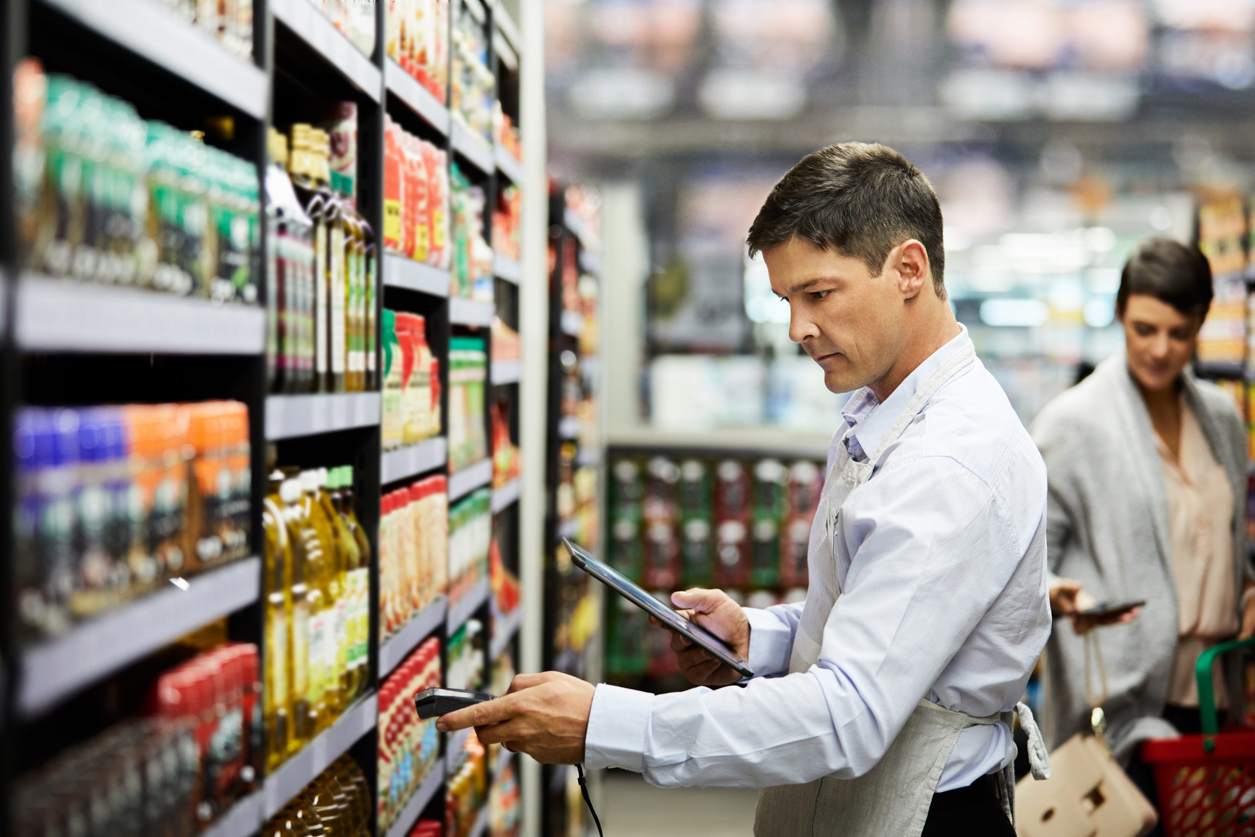 4k video footage of a store worker scanning products in a supermarket